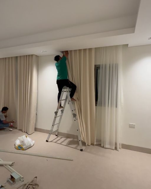 Jan Furnishings installing curtains